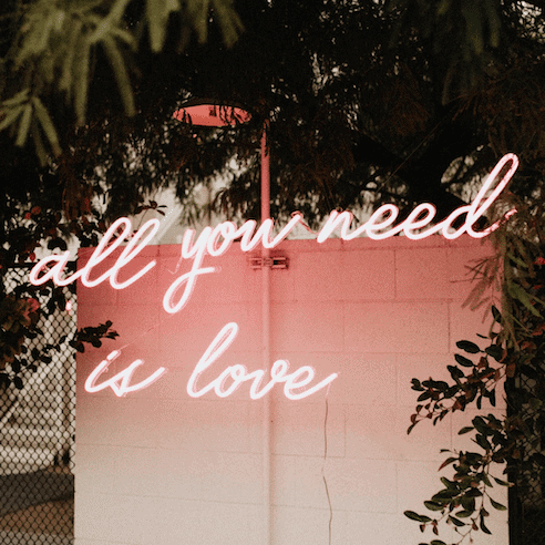 all you need is love pink neon light
