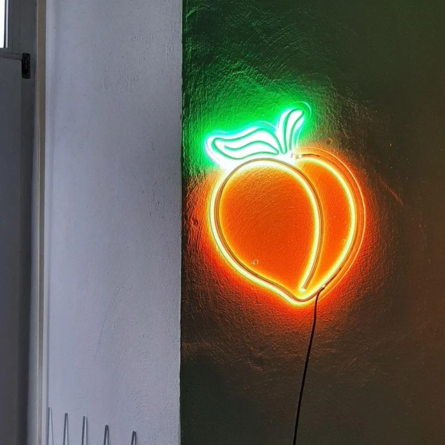 Green And Orange Peach Led Neon Light On The Wall