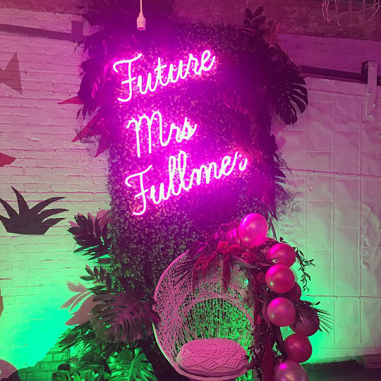custom hot pink led neon sign on faux green wall
