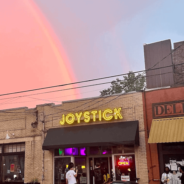 Joystick outside glass outdoor neon sign