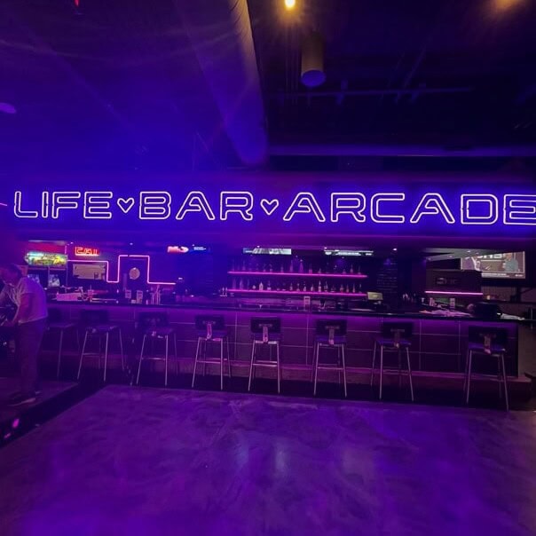 large size neon sign in purple for arcade